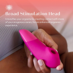 Close-up of Womanizer Enhance showing broad stimulation head and separate controls for Pleasure Air and vibration motors