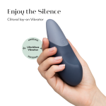 Close-up of Womanizer Vibe showing Pleasure Edges ergonomic shape, Autopilot controls and magnetic USB charging pins in body-safe silicone
